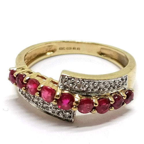 461 - 9ct hallmarked gold ruby / diamond crossover ring - size O½ & 2.6g total weight