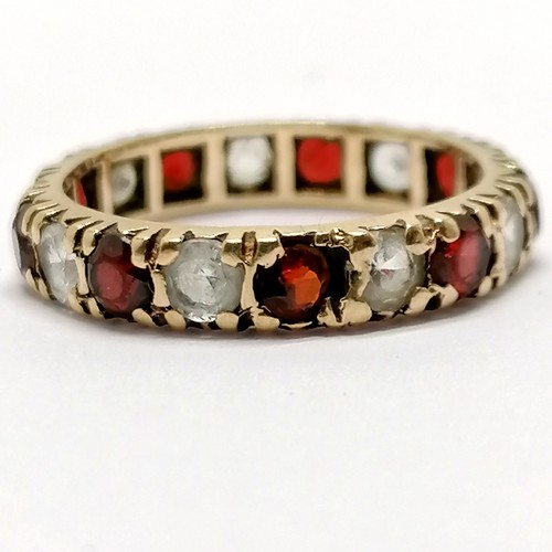 491 - Unmarked gold red /white stone eternity ring - size J & 2g total weight