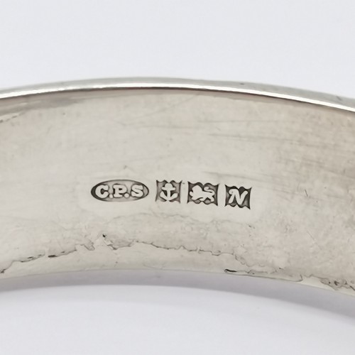 535 - Silver hallmarked bangle with engraved detail to front - 6.5cm across & 21g ~ has 1 slight dent