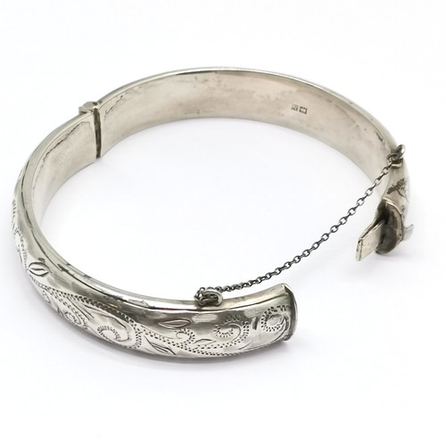 535 - Silver hallmarked bangle with engraved detail to front - 6.5cm across & 21g ~ has 1 slight dent