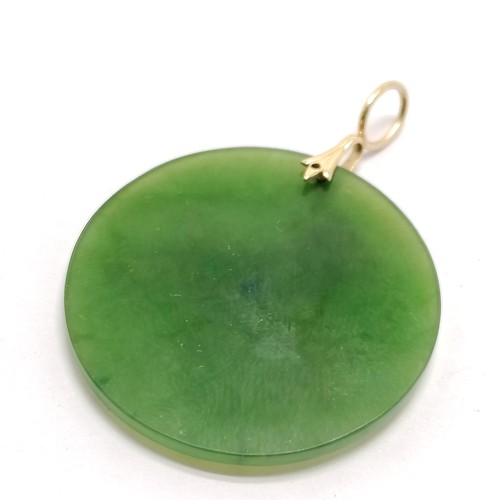 569 - Hardstone jade circular pendant with unmarked (touch tests as 14ct) horse detail & bale mount - 3.2c... 