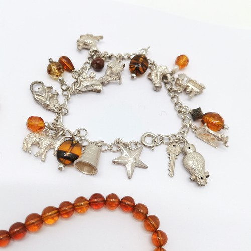 590 - Silver charm bracelet with charms (35g) t/w strand of amber beads (40cm & 8.4g total weight)