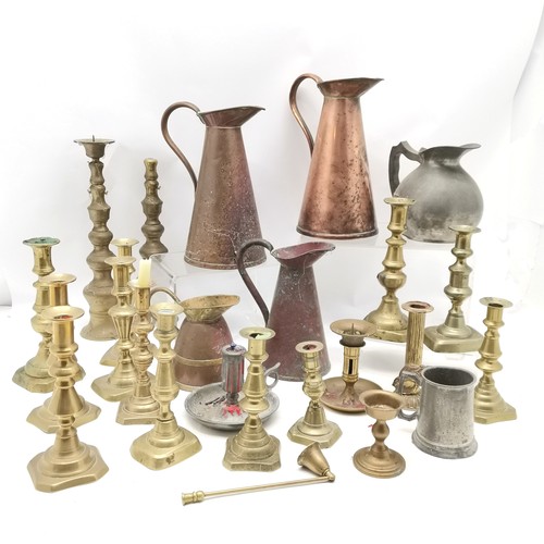 111 - Qty of mostly antique brass candlesticks (inc Georgian) t/w 3 copper jugs (tallest 27cm) etc