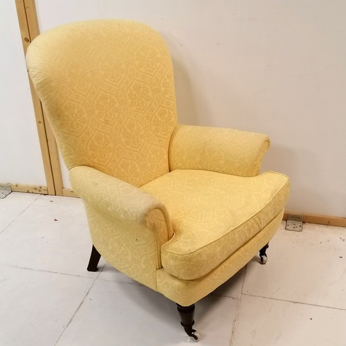 126 - Antique ladies yellow upholstered wing armchair with leather seat cushion- some marks to the fabric