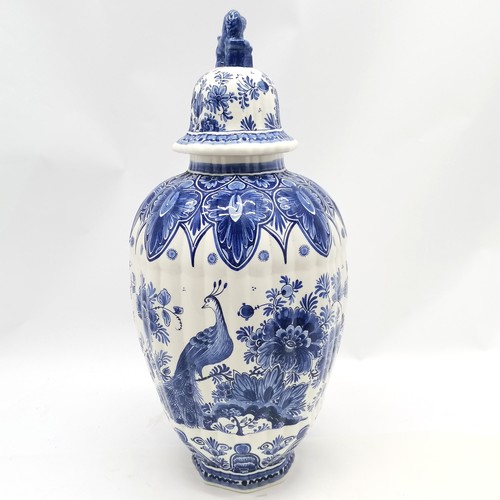 156 - Delft blue and white lidded ribbed vase with peacock decoration & marks to base with lion dog finial... 