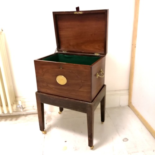 246 - Antique mahogany box with brass fittings and oval inlaid detail on stand terminating on 4 brass cast... 