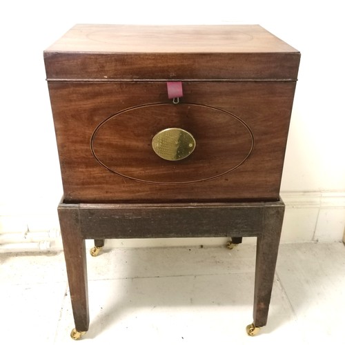 246 - Antique mahogany box with brass fittings and oval inlaid detail on stand terminating on 4 brass cast... 