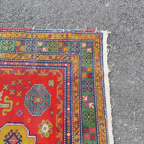 309 - Persian wool rug red grounded hand woven with geometric design - 235cm x 170cm - has some losses