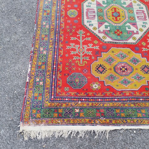 309 - Persian wool rug red grounded hand woven with geometric design - 235cm x 170cm - has some losses