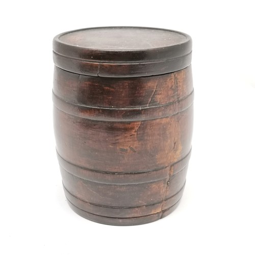 339 - Antique carved wooden box as a barrel 14cm high x 10.5cm diameter - has a split to the body