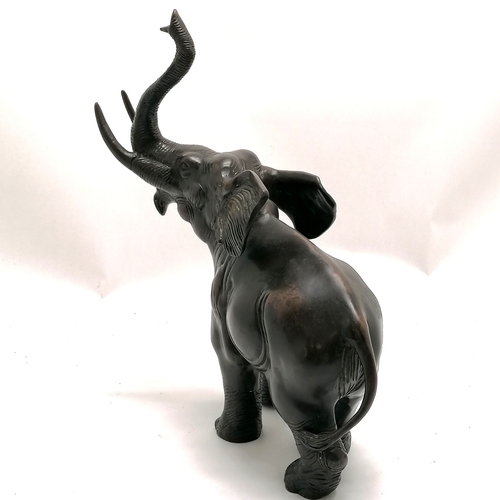 6 - Bronze figure of an elephant with it's trunk raised 32.5cm high x 26cm long - no obvious damage