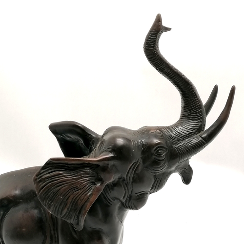 6 - Bronze figure of an elephant with it's trunk raised 32.5cm high x 26cm long - no obvious damage