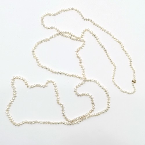 677 - Long strand (164cm) of freshwater pearls with 9ct gold clasp