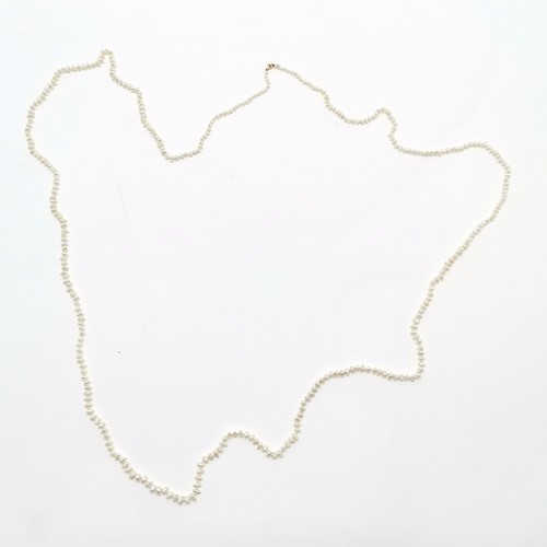 677 - Long strand (164cm) of freshwater pearls with 9ct gold clasp