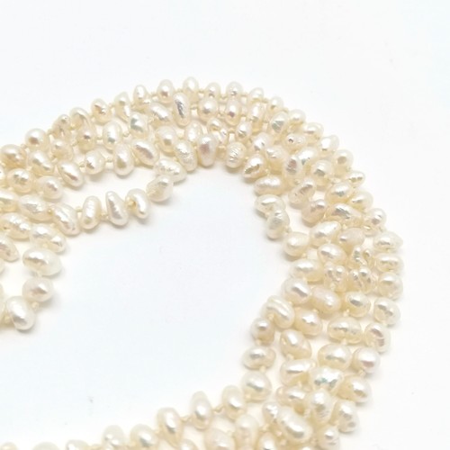 677 - Long strand (164cm) of freshwater pearls with 9ct gold clasp