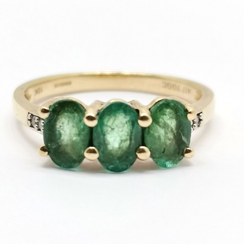 692 - 9ct hallmarked gold 3 stone emerald ring with diamond set shoulders - size L½ & 1.9g total weight