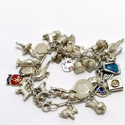 707 - Unmarked silver charm bracelet with charms inc sphinx, enamel detail, witch on broomstick, owl etc -... 