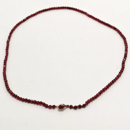 771 - Antique strand of small red beads with unmarked gold stone set clasp - 44cm long