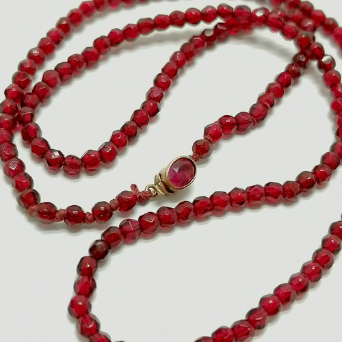 771 - Antique strand of small red beads with unmarked gold stone set clasp - 44cm long