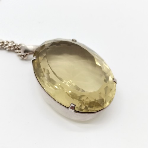 793 - Large citrine stone set unmarked silver pendant (42mm x 31mm) on silver 55cm chain - total weight 59... 