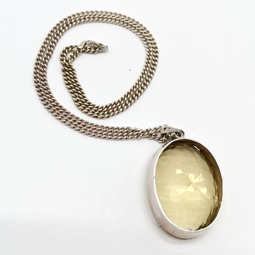 793 - Large citrine stone set unmarked silver pendant (42mm x 31mm) on silver 55cm chain - total weight 59... 