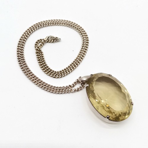 793 - Large citrine stone set unmarked silver pendant (42mm x 31mm) on silver 55cm chain - total weight 59... 