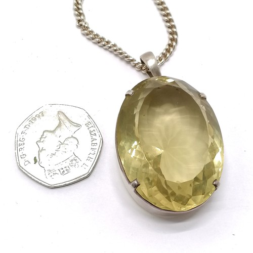 793 - Large citrine stone set unmarked silver pendant (42mm x 31mm) on silver 55cm chain - total weight 59... 