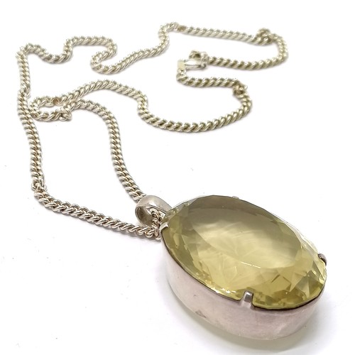 793 - Large citrine stone set unmarked silver pendant (42mm x 31mm) on silver 55cm chain - total weight 59... 