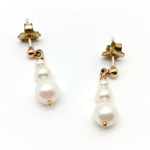 853 - 9ct gold mounted pair of pearl drop earrings - 2.2cm drop & 2.3g total weight