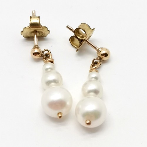 853 - 9ct gold mounted pair of pearl drop earrings - 2.2cm drop & 2.3g total weight