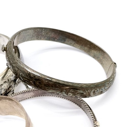 867 - 4 x silver bangles - widest (6cm across) engraved has slight dents to back ~ 84g & SOLD ON BEHALF OF... 