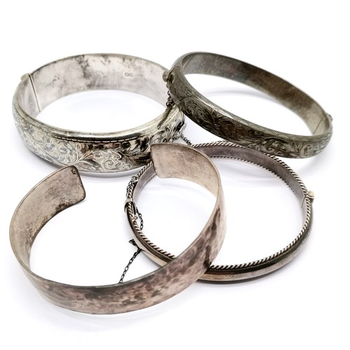 867 - 4 x silver bangles - widest (6cm across) engraved has slight dents to back ~ 84g & SOLD ON BEHALF OF... 