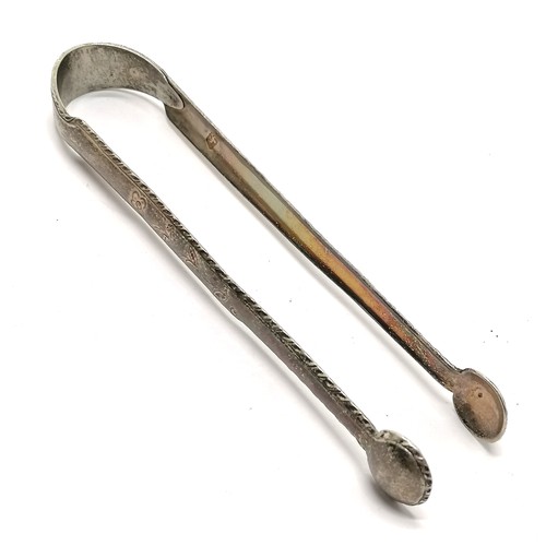 960 - 18th century silver sugar tongs with floral decoration to arms by Stephen Adams (?) - 12.5cm & 25g