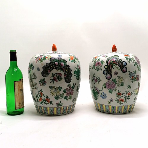 46 - Pair of famille rose lidded jars 30cm high with character marks to the base of one - no obvious dama... 