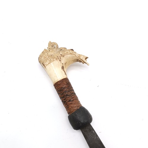 70 - Borneo dayak mandau sword in scabbard - with a carved stag horn hilt - total length 70cm