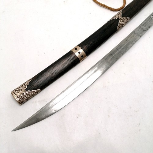 103 - Antique Burmese / Asian Mandalay region sword with unmarked silver mounts & inlay to blade in an ebo... 