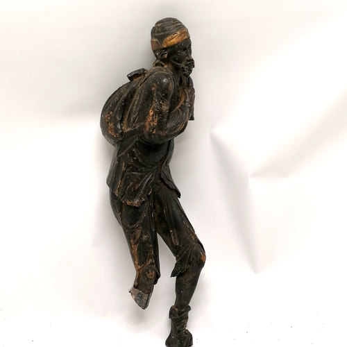 167 - Antique carved wooden figure of an eastern gentleman carrying a sack - 44cm high - has obvious losse... 