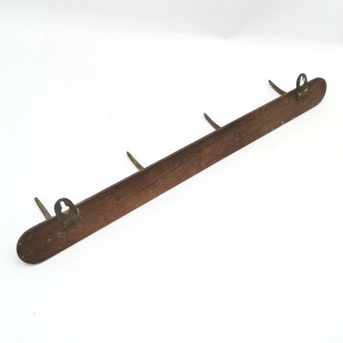 184 - Antique coat / tack hooks on a mahogany plaque (No 8) - 59cm across