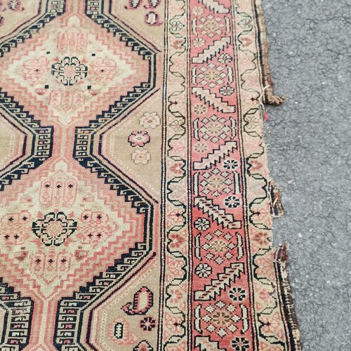 242 - Red grounded hand woven rug runner with geometric repeat pattern and central medallion detail - 305c... 