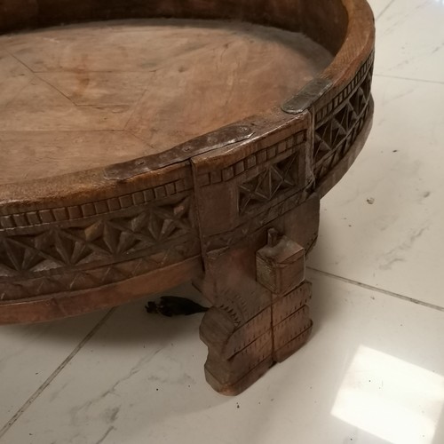 256 - Antique Indian chakki style coffee table with iron fittings on 4 legs - 69cm diameter