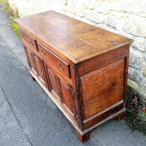 466 - Antique oak dresser base with fielded panelled detail to the doors and sides, oak drawer linings and... 