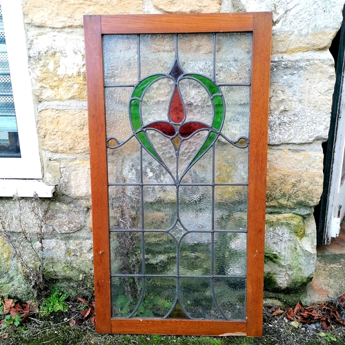 470 - Art Nouveau stained glass panel in an oak frame - loss to the frame - 54cm x 99.5cm