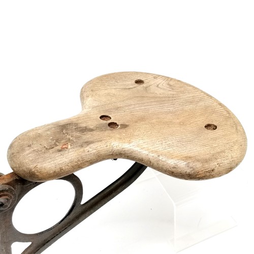 474 - Industrial wooden seat on a cast metal bracket with ER cypher - 41cm across x 34cm high