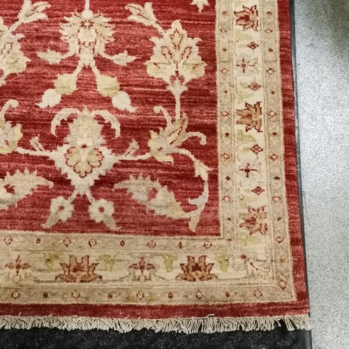 527 - Afghan red grounded wool rug 93cm x 160cm - in good used condition