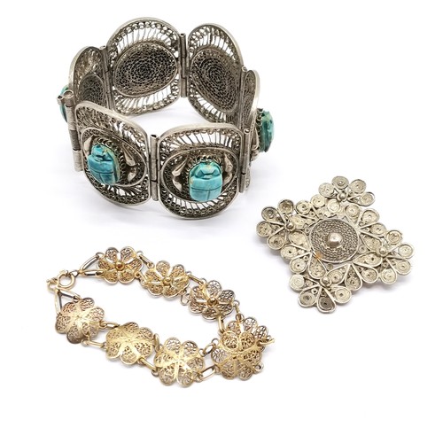 288 - Unmarked silver filigree bracelet with scarab detail 17cm long T/W a similar bracelet and brooch tot... 