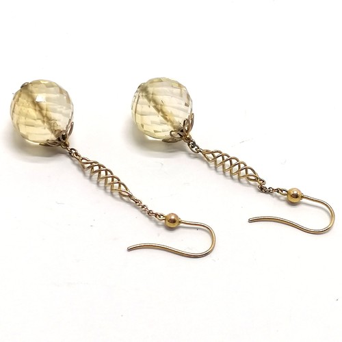 310 - Unmarked gold earrings set with facetted citrine drops - 4.5cm drop & 7.6g total weight ~ both stone... 