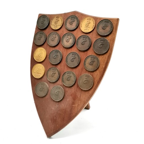 156 - Wooden trophy shield mounted with Royal Ocean Racing Club medals 1947-1962 - shield 43cm x 30cm