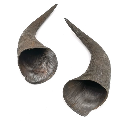 245 - Pair of tribal horns with prolific carved detail - longest 35cm and both are a/f