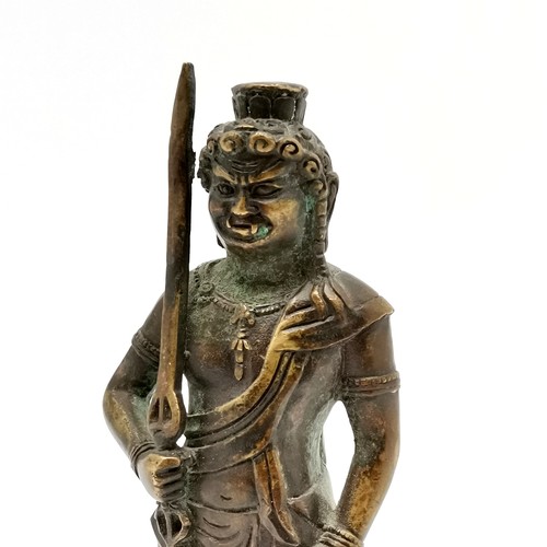 63 - Asian bronze cast deity with sword - 22cm high