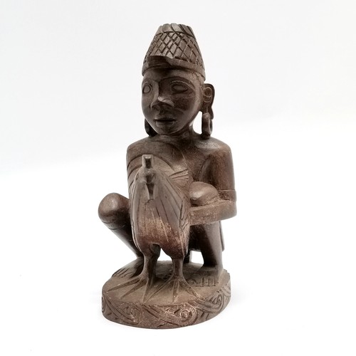 66 - Asian hand carved wooden figure of crouching man holding large cockerel- 23cm high